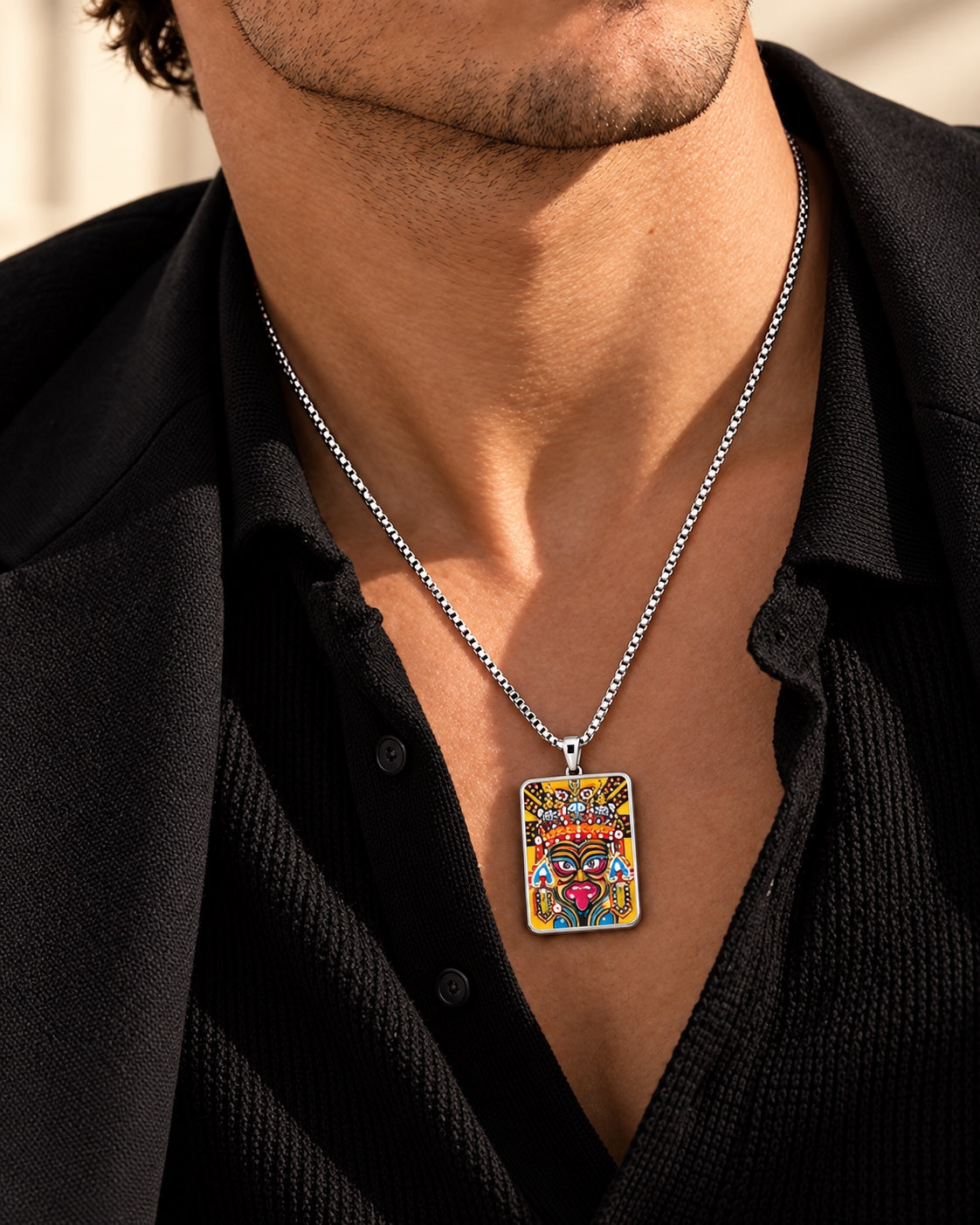 Male model wearing the hand-painted Zaki Lhamo Thangka necklace in black tailoring